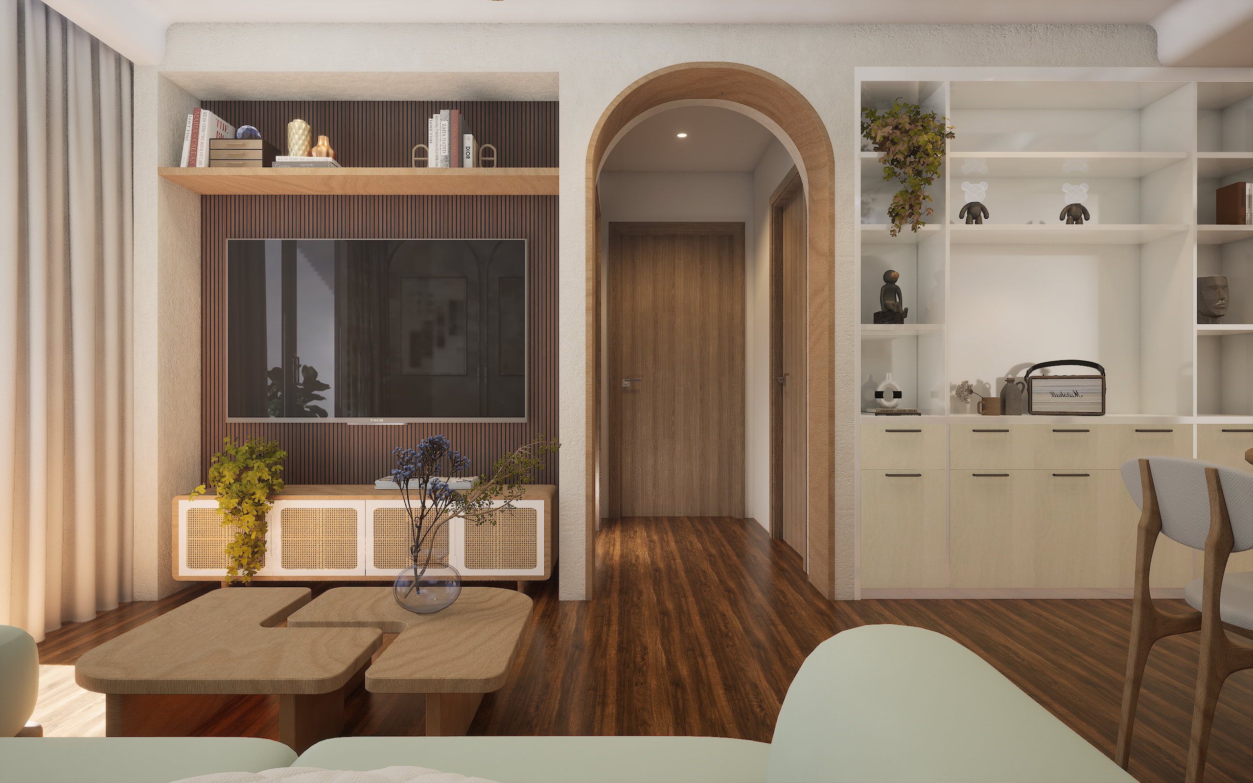 A cozy and modern living room with a wooden floor and accent wall, white sofa, wooden coffee table, built-in bookshelf, TV mounted on the wall, and plants.