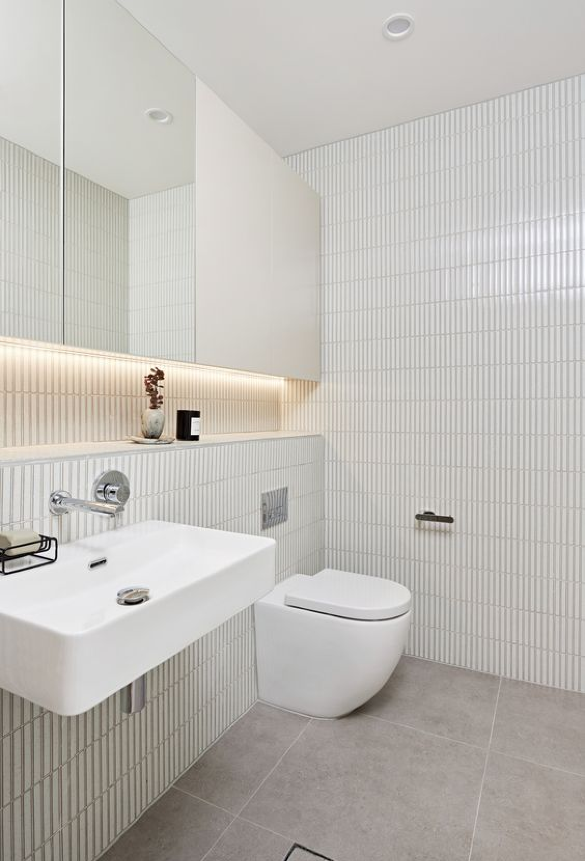 Minimalist White Bathroom with Vertical Tile Accents and Floating Fixtures | Material Depot