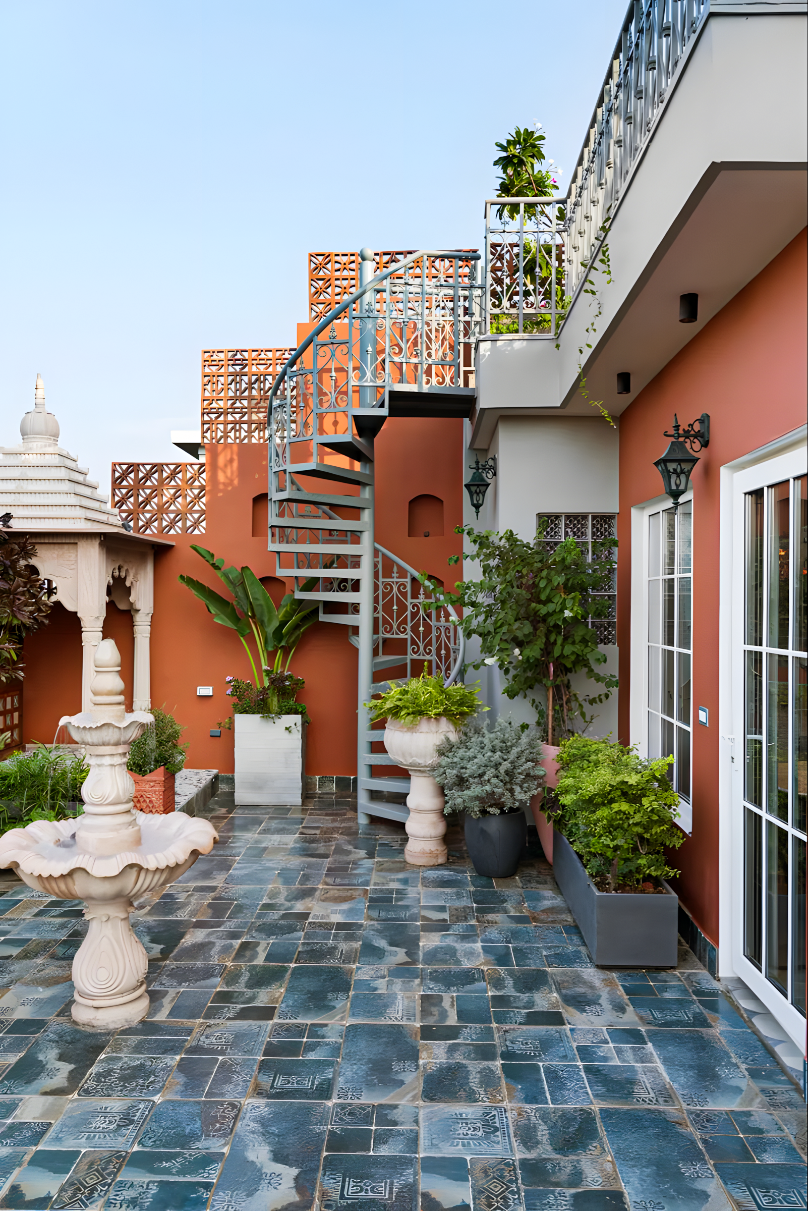 Modern Rooftop Terrace with Spiral Staircase and Colorful Decor | Material Depot