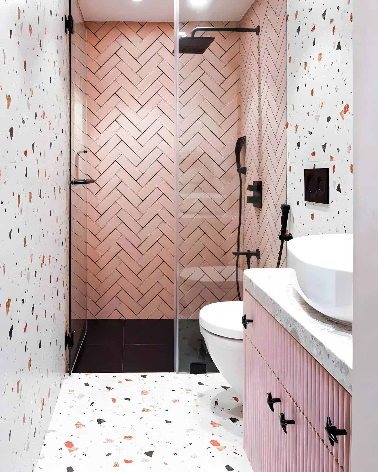 Soft Pink Herringbone Tiles with Bold Terrazzo Accents in a Modern Bathroom | Material Depot